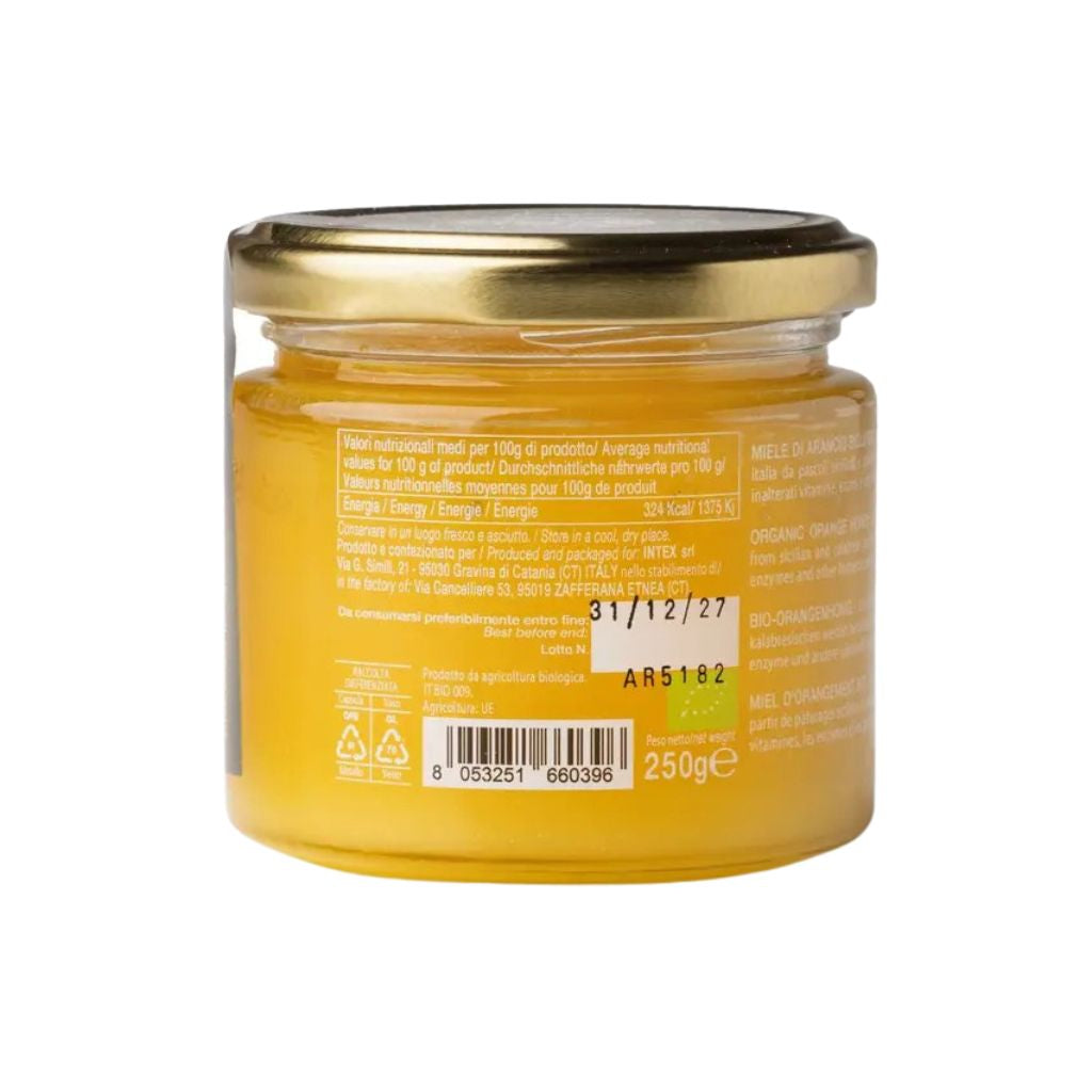 Glas mit Orangenblütenhonig und Deckel, Honig im Glas sichtbar, naturbelassen, cremige Textur, Detailaufnahme der Glasrückseite.