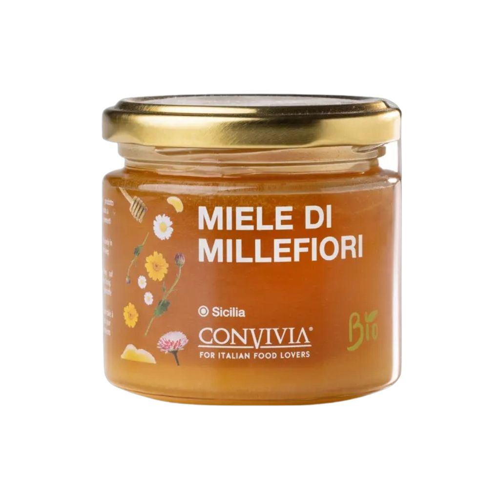 Glas mit Wildblütenhonig und Deckel, Honig im Glas sichtbar, naturbelassen, cremige Textur, bernsteinfarbener Honig sichtbar, Detailaufnahme der Glasvorderseite.