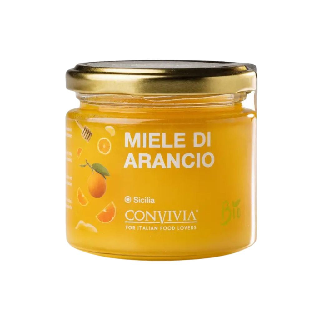 Glas mit Orangenblütenhonig und Deckel, Honig im Glas sichtbar, naturbelassen, cremige Textur, Detailaufnahme der Glasvorderseite.